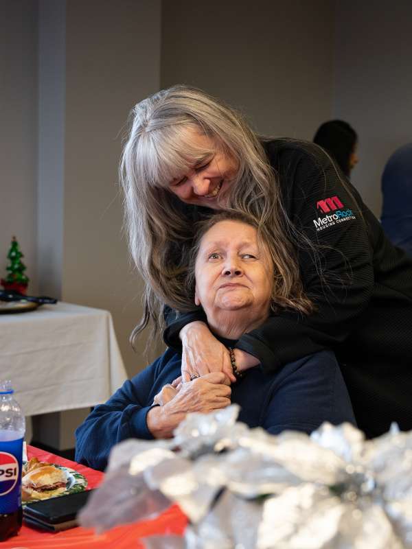 A friendly gathering between a MetroRock employee and guest.