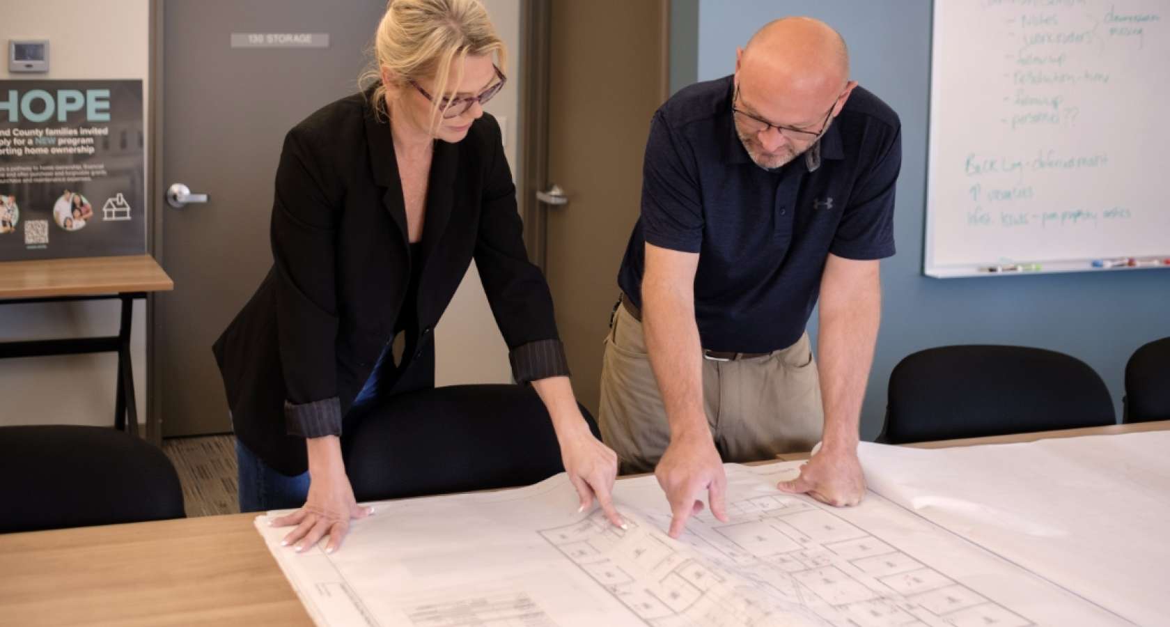 Amy Clark and Andy West looking over design plans.